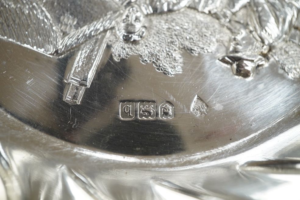 A late Victorian silver shallow dish embossed with imbibers, Mappin Brothers, London, 1897, 13.5cm, 3.8oz. Condition - good